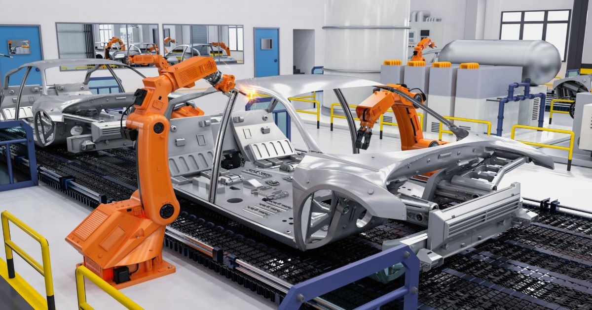 Robotic arms assembling vehicle frames in a factory.