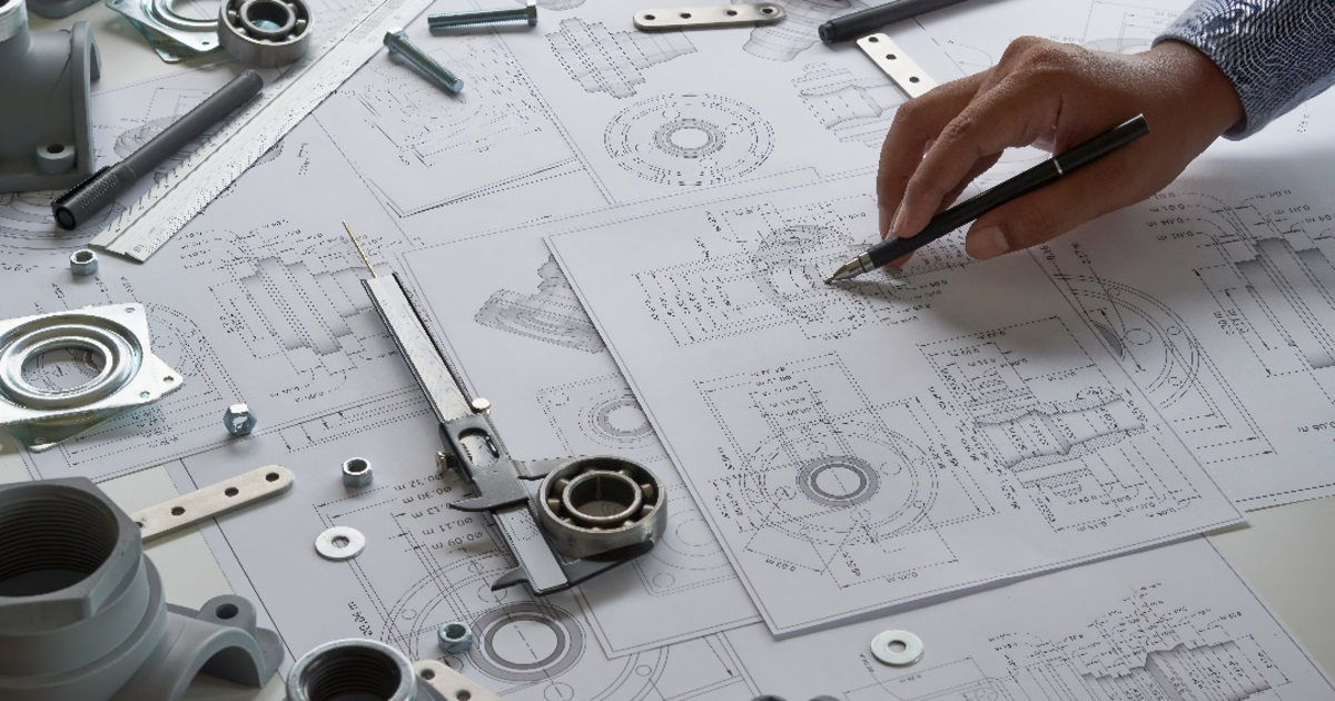 Technical drawings and CAD conversion services on a workspace.