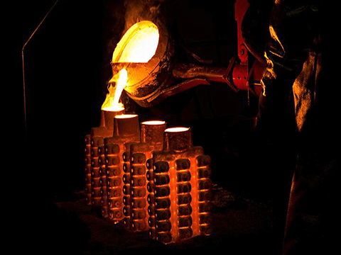 Filling molds with molten metal in investment casting.