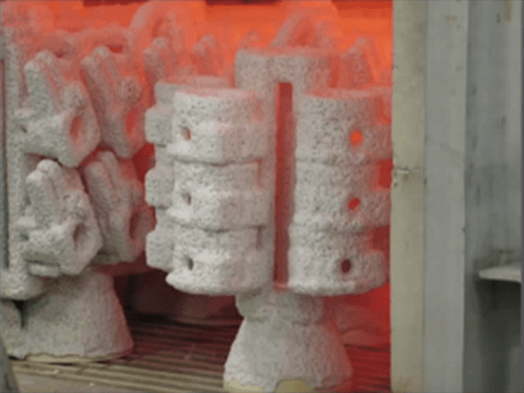 Dewaxing process in investment casting with heated molds.