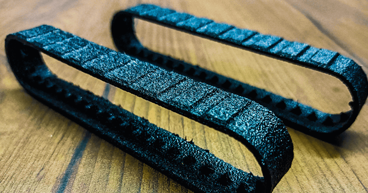 FDM 3D printer using PLA, ABS, and PETG thermoplastics with blue filament.