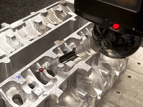 Close-up of investment casting inspection process with measuring tool.