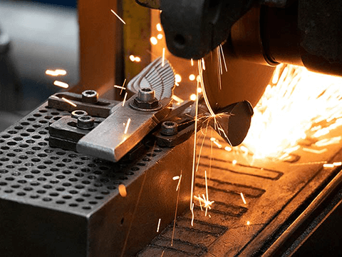  Close-up of investment casting cut-off process with sparks flying.