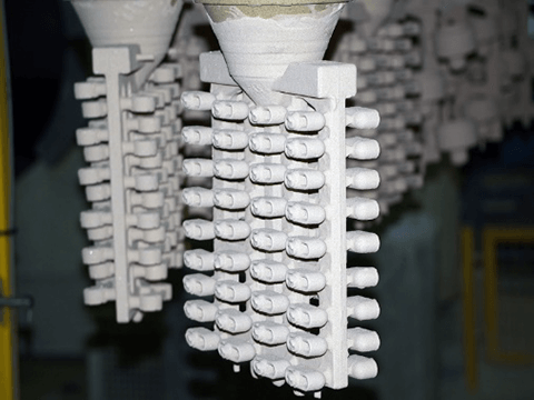 Close-up of investment casting wax assembly showing multiple wax patterns.