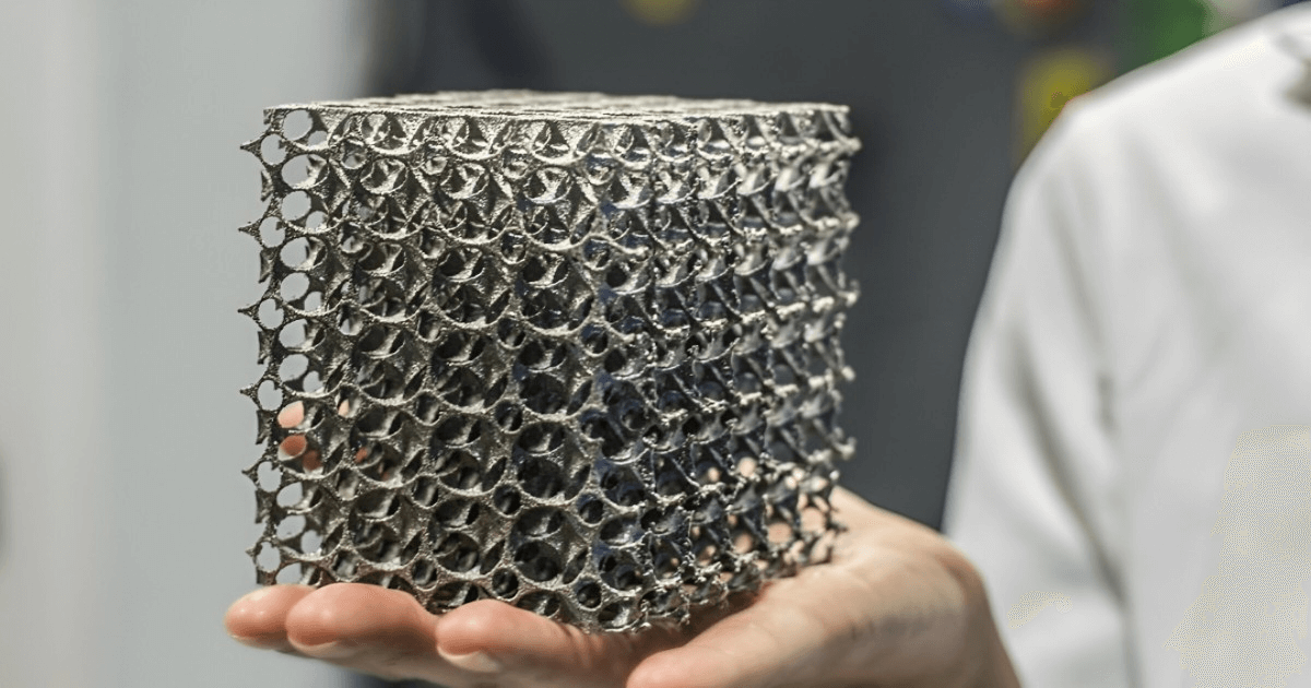  A person holds a metal mesh cube, showcasing the precision of metal 3D printing services.