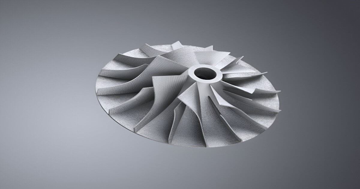 A metallic turbine or compressor impeller with curved blades, created using metal 3d printing services.