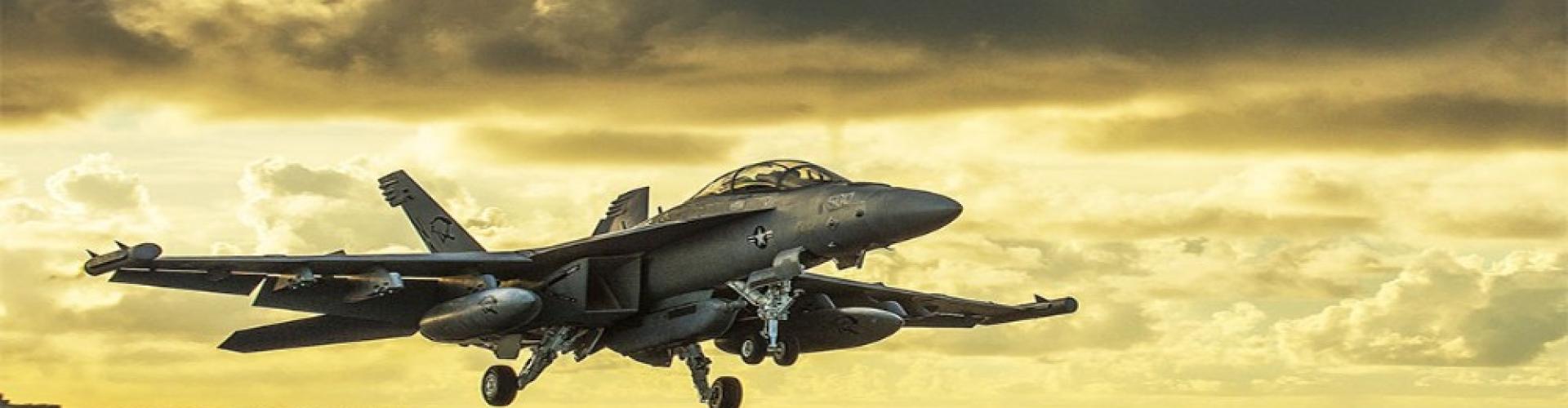 A fighter jet flies over the ocean, representing advancements in aerospace and defense capabilities.