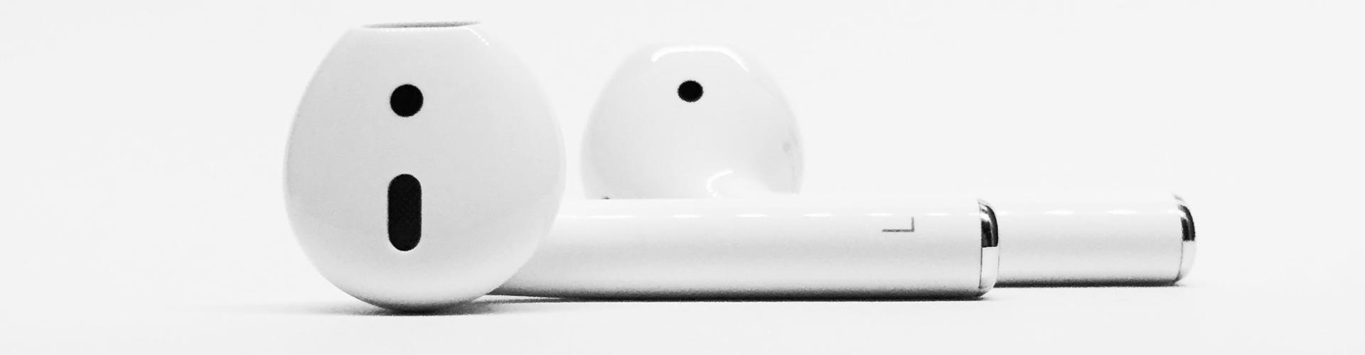 AirPods 2 with wireless charging case, showcasing sleek design and modern consumer technology.